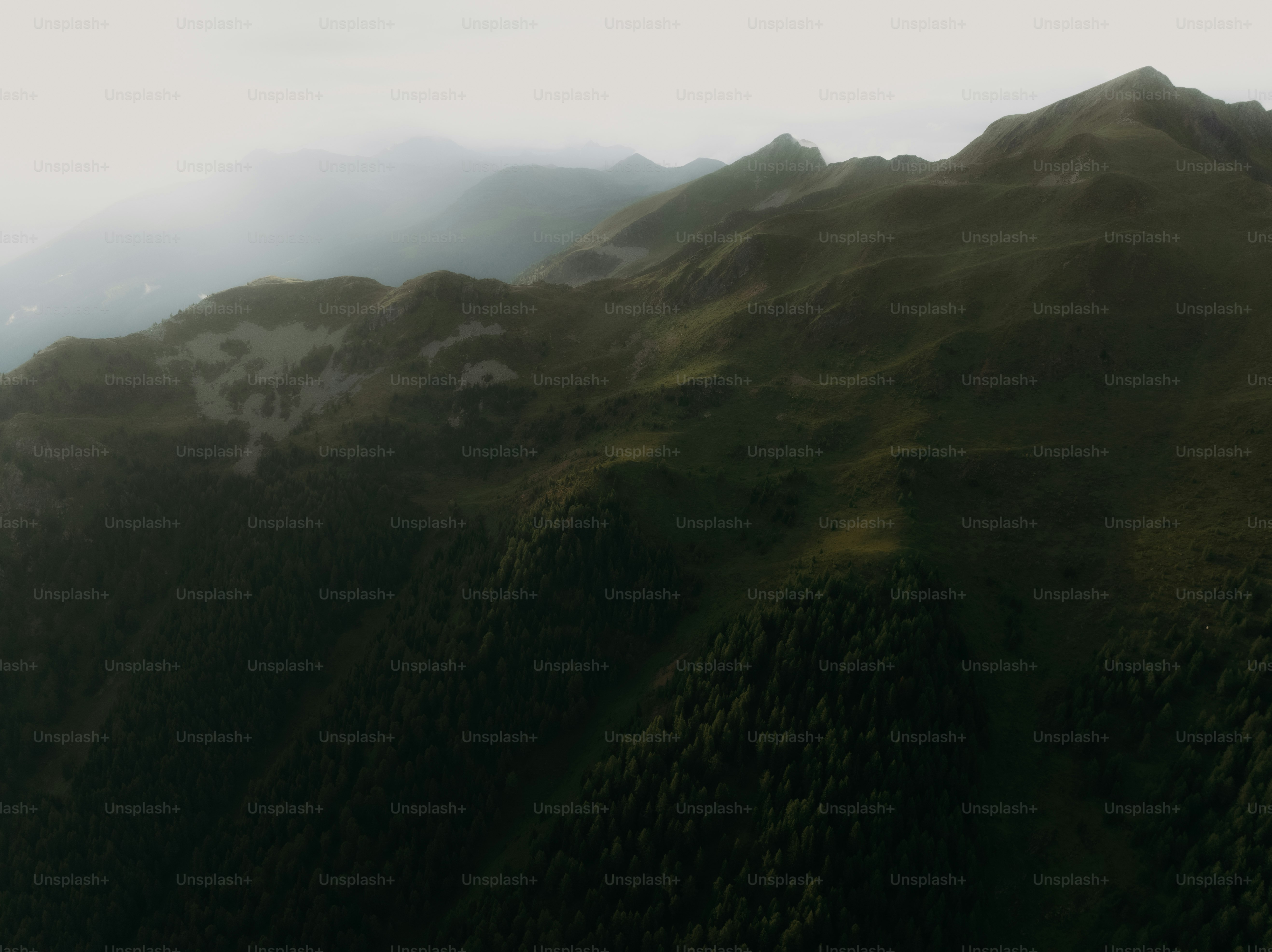 an aerial view of a green mountain range