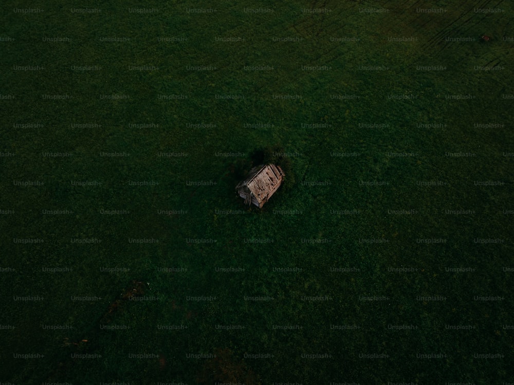 an aerial view of a house in the middle of a field