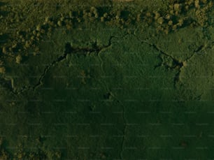 an aerial view of a green area with dirt and grass