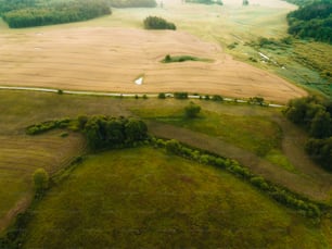 an aerial view of a farm land with a river running through it