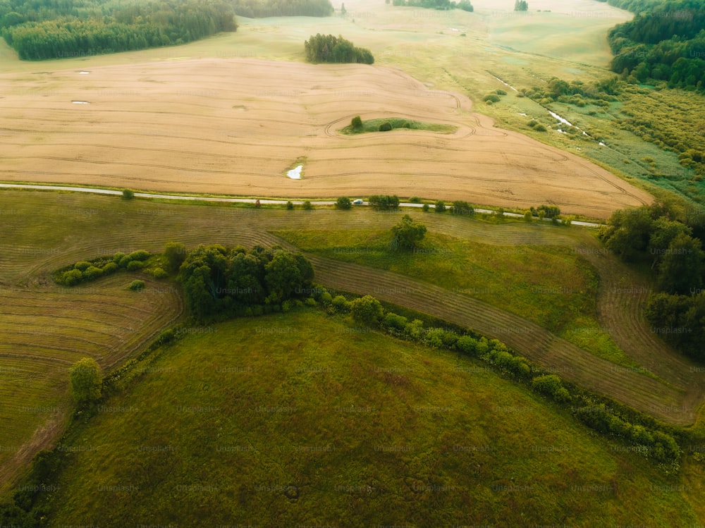 an aerial view of a farm land with a river running through it