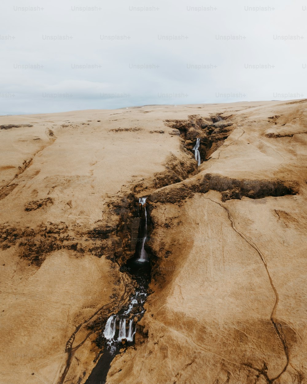 a stream of water running through a desert landscape