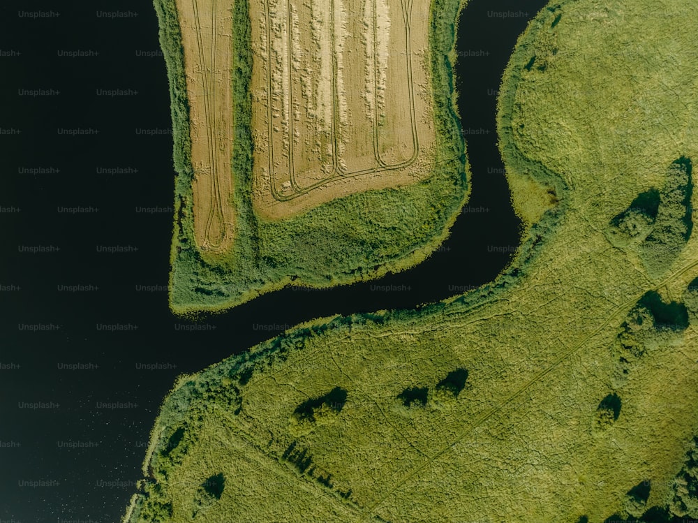 an aerial view of a field and a river
