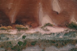 an aerial view of a sandy beach and a body of water