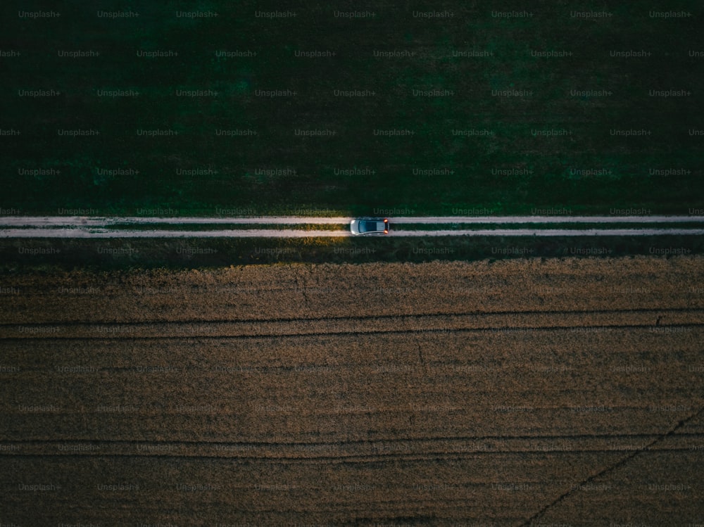 an aerial view of a tractor in a field