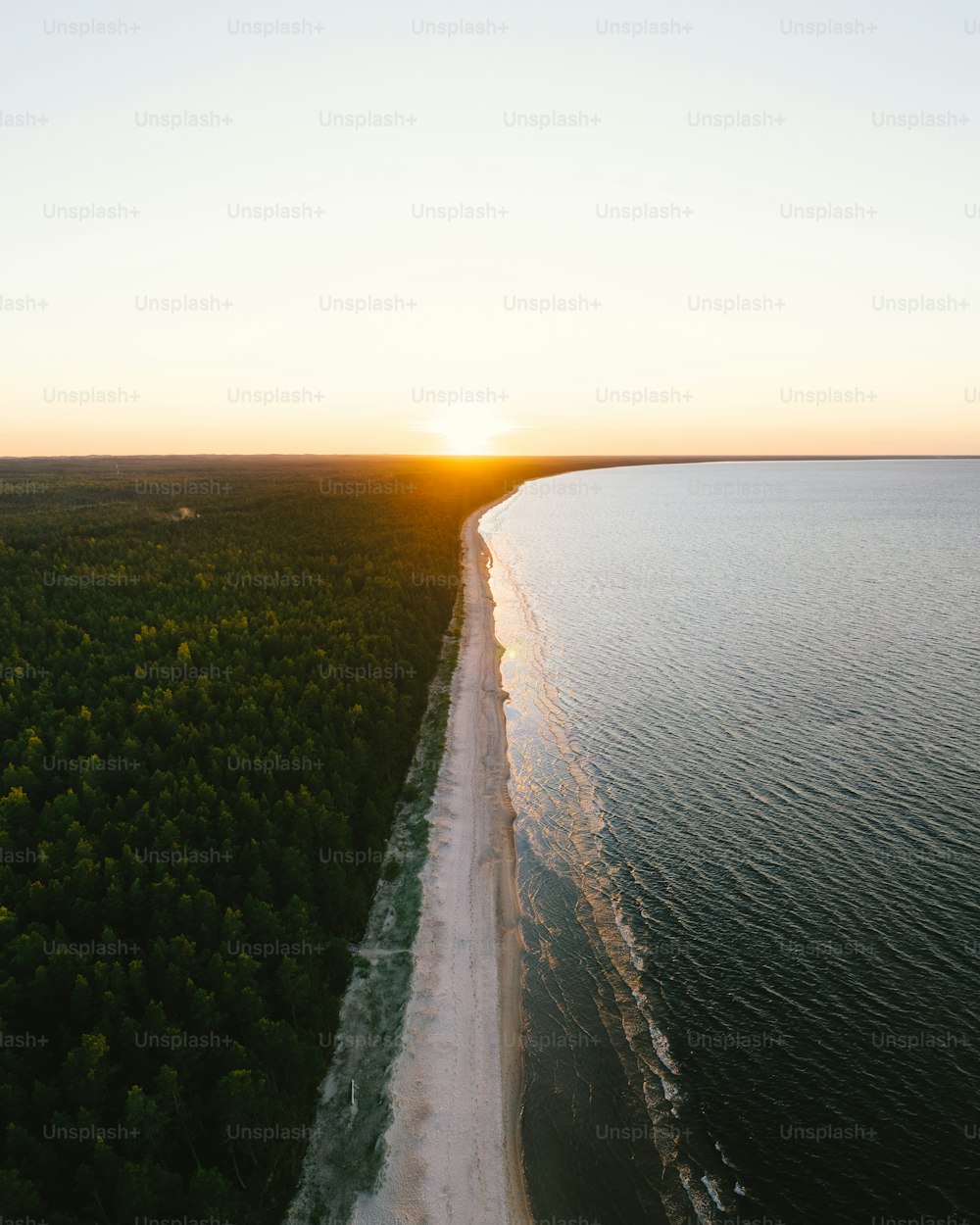 an aerial view of a beach at sunset