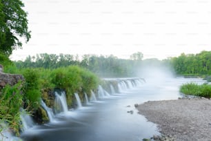 a river with a waterfall in the middle of it