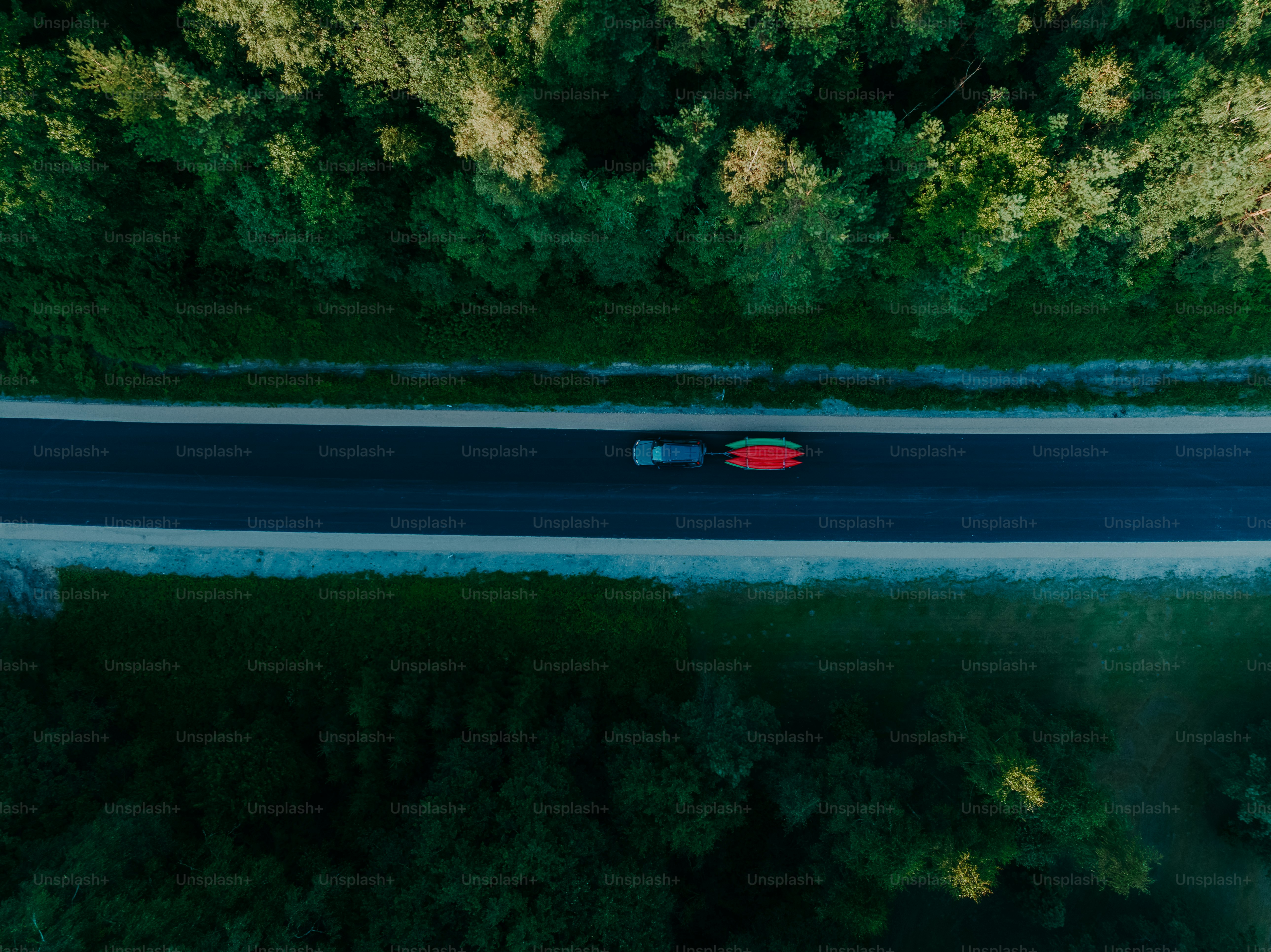 an aerial view of a car driving down a road