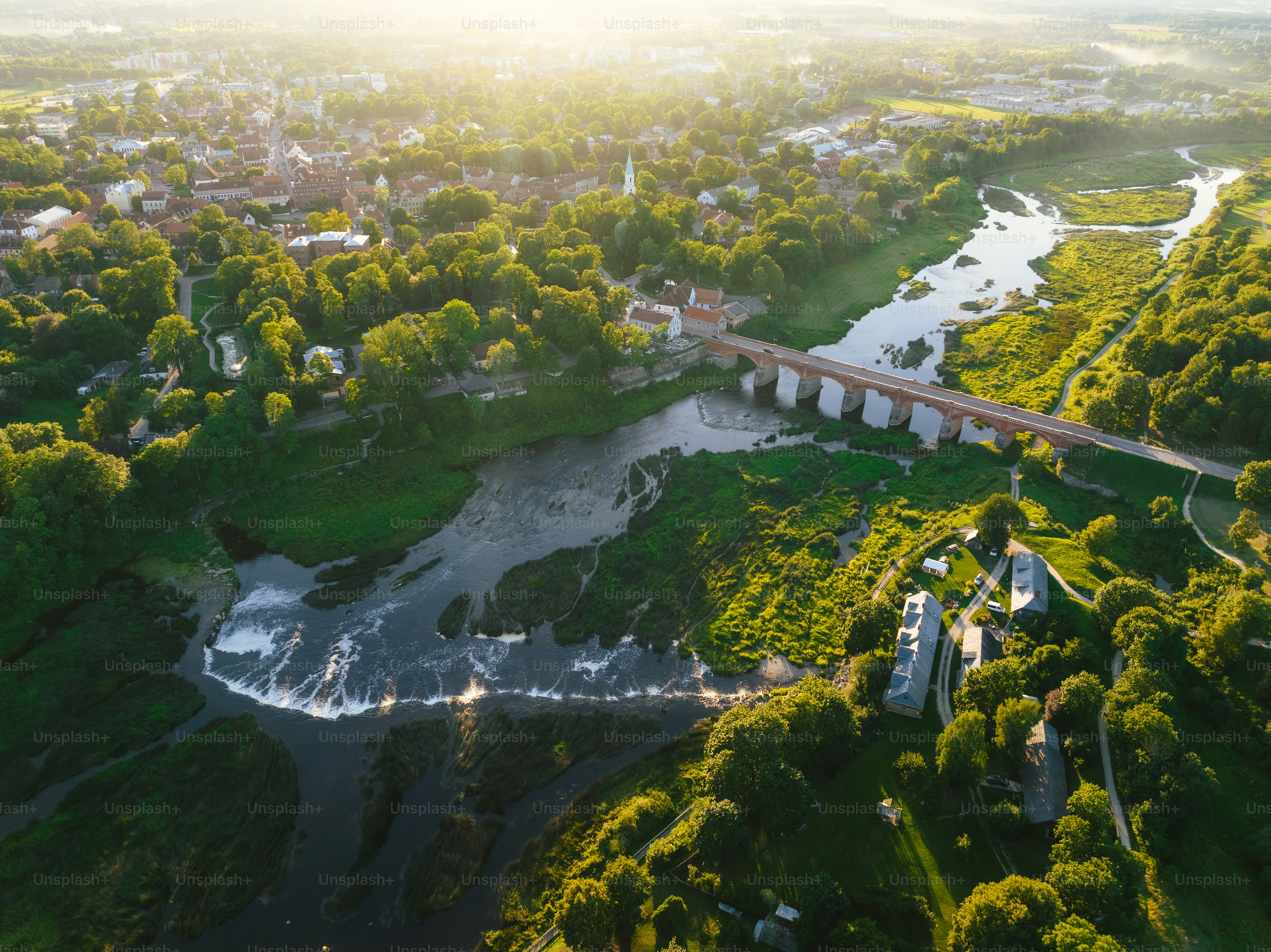 an aerial view of a river and a bridge