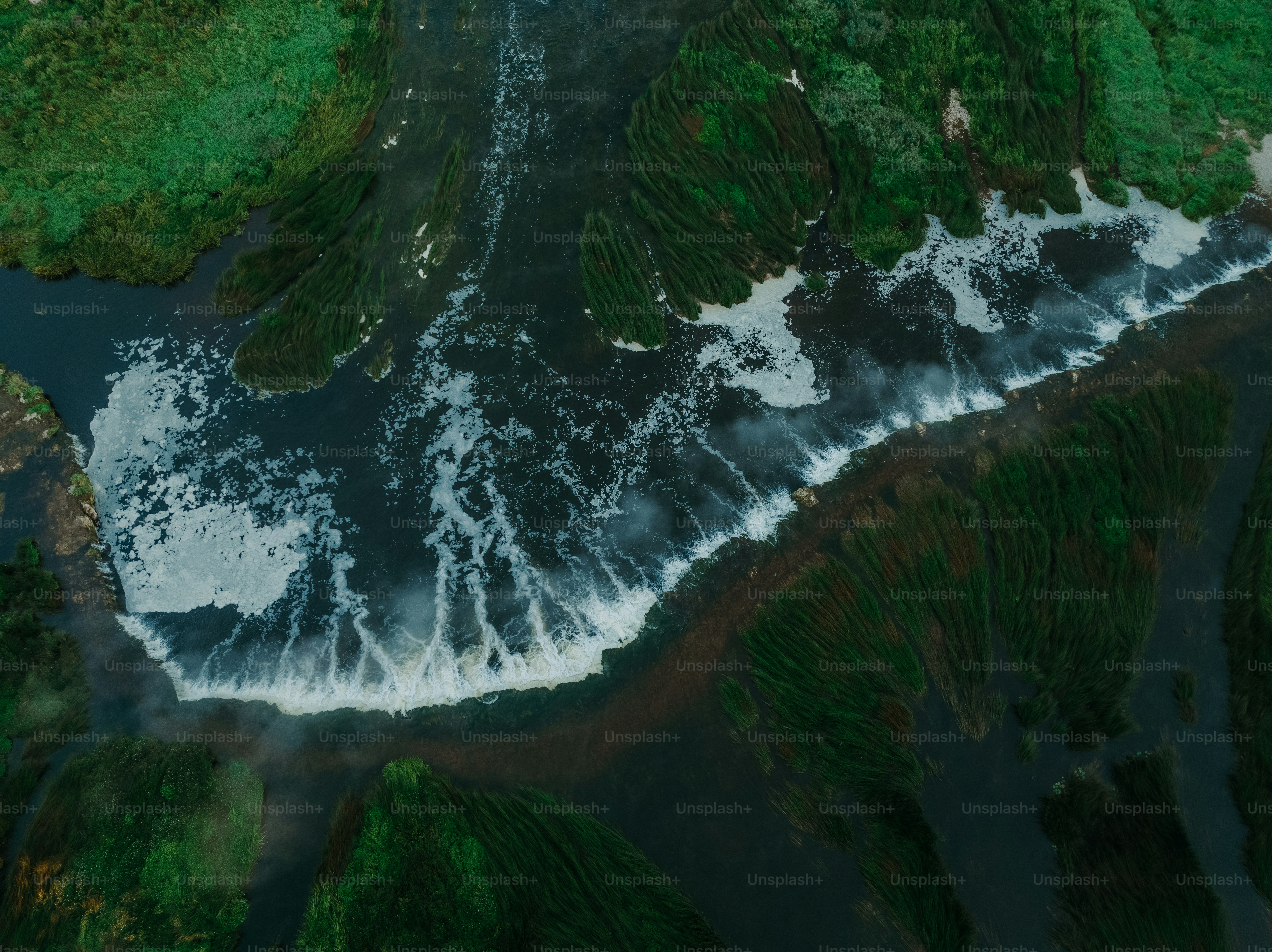 an aerial view of a body of water surrounded by land