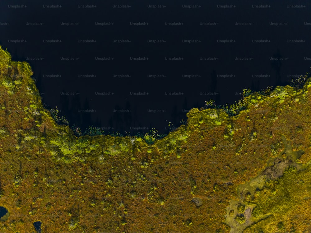 an aerial view of a mountain with a dark sky in the background