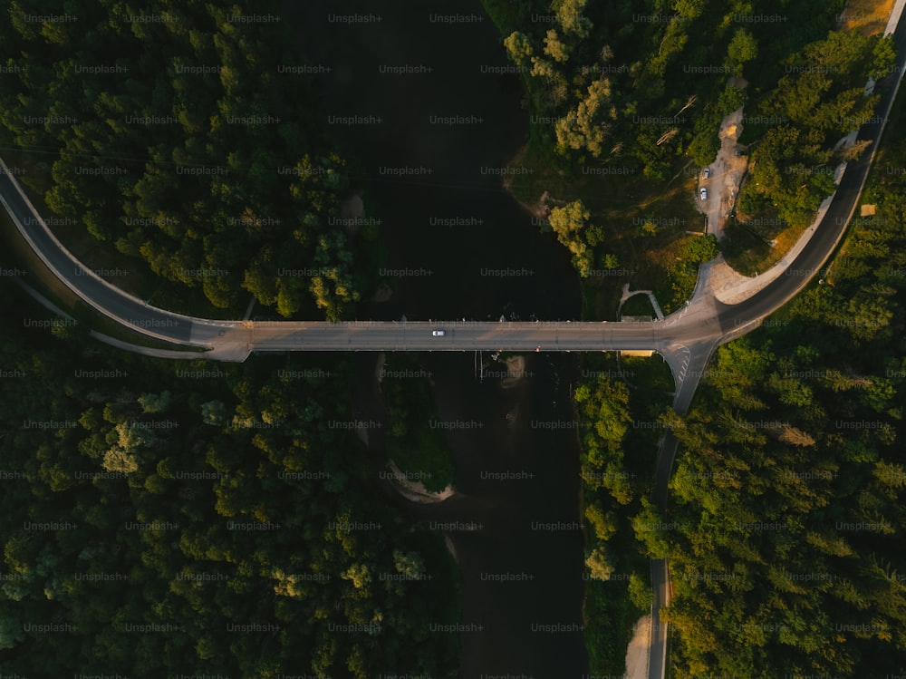 an aerial view of a road in the middle of a forest