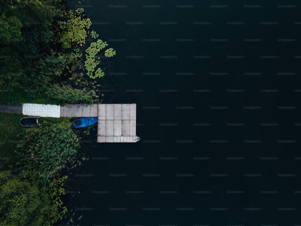 a blue boat sitting on top of a body of water