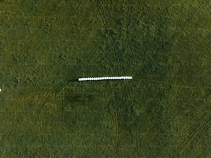 an aerial view of a field with a white object in the middle of it