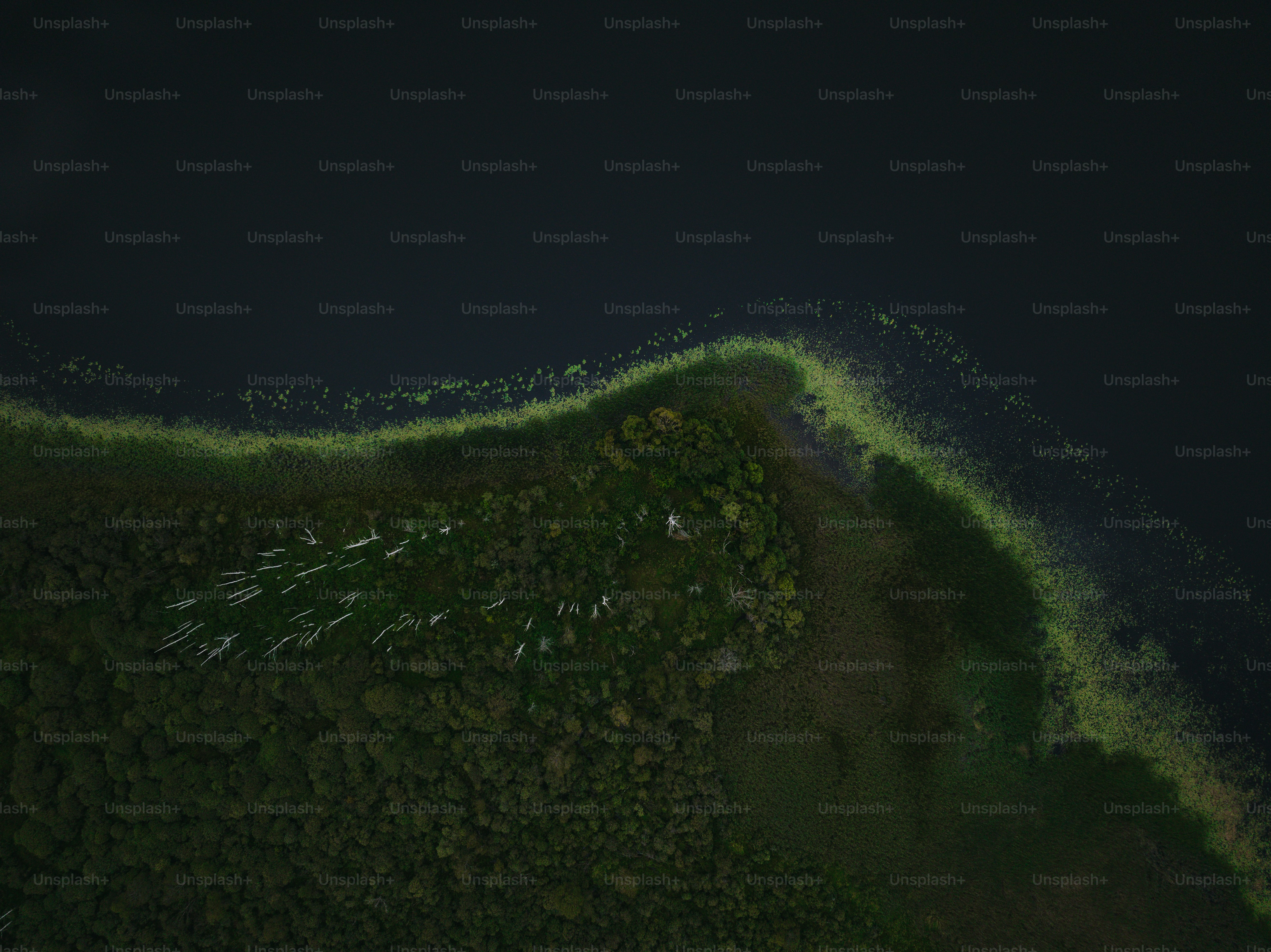 an aerial view of a body of water at night