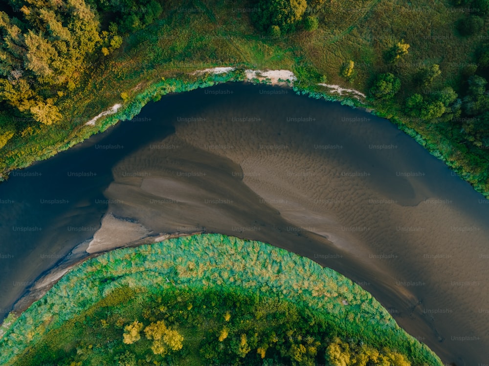 an aerial view of a body of water surrounded by trees