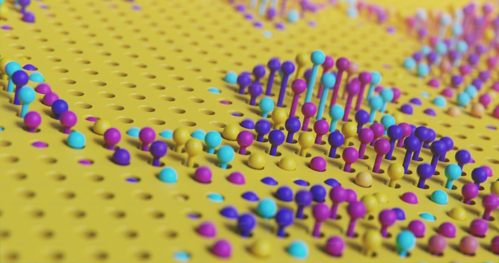 a bunch of colorful dots on a yellow surface
