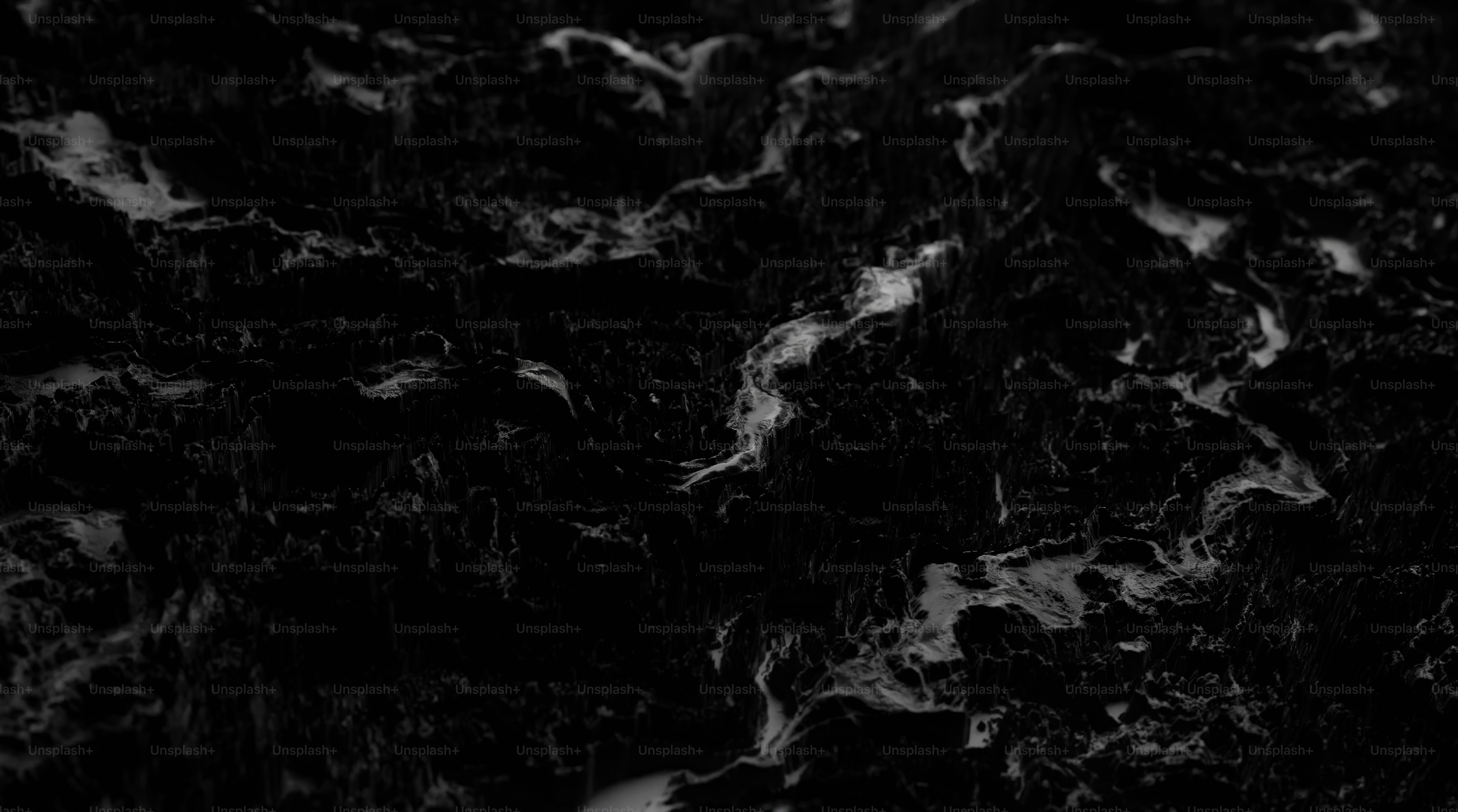 a black and white photo of water and rocks