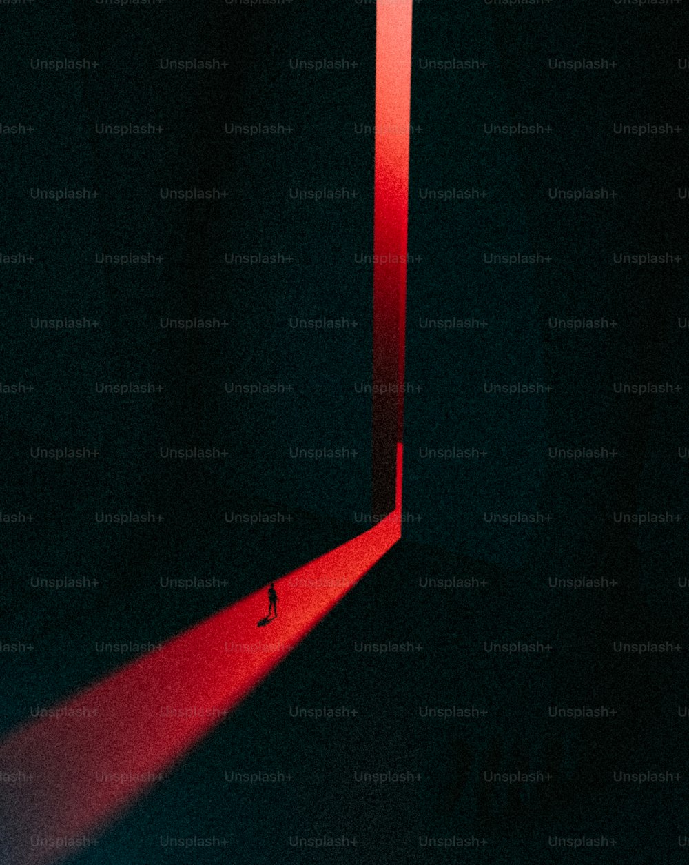 a red light shining through a mirror in a dark room