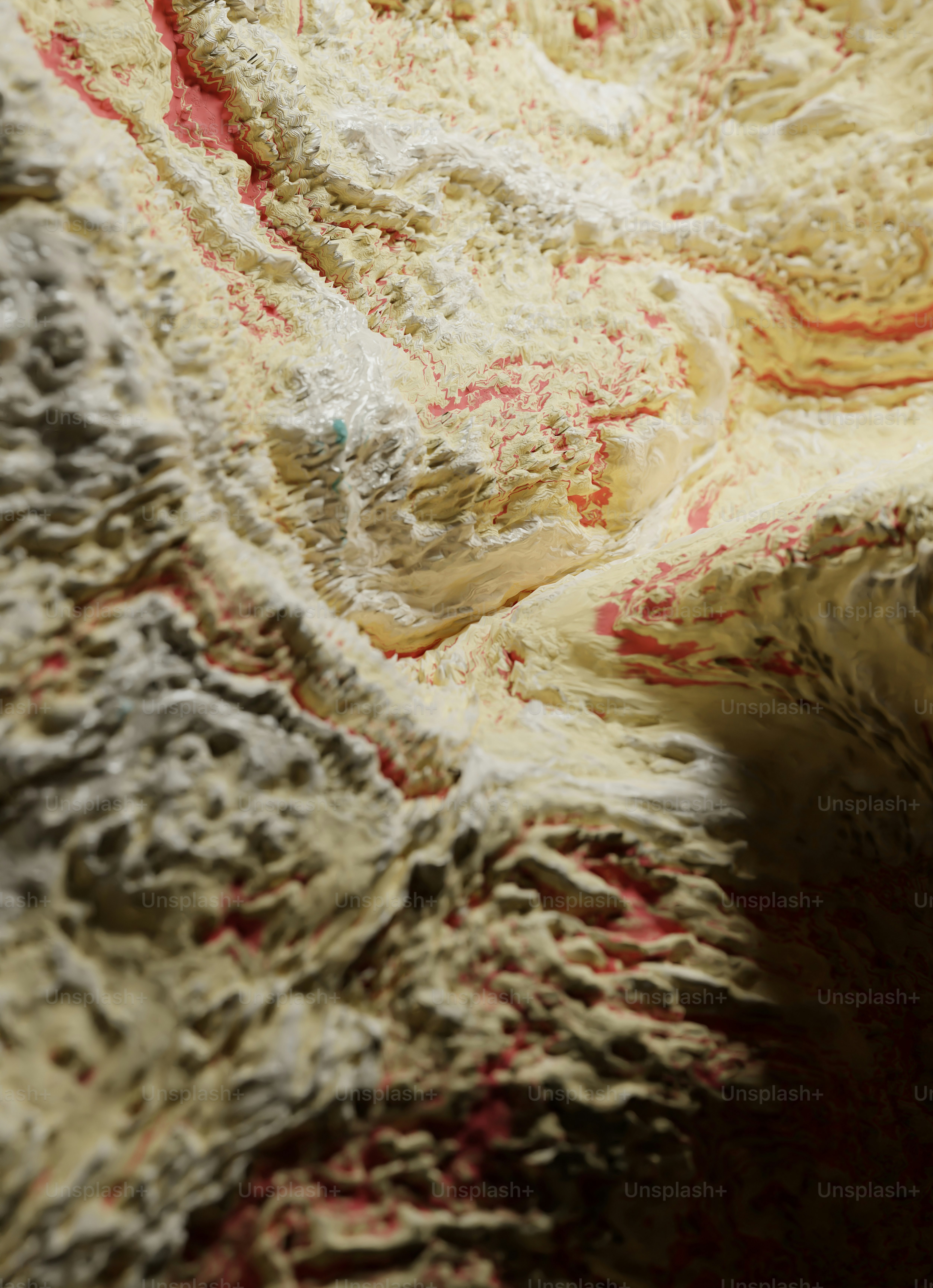 a close up of a rock with red and white paint on it