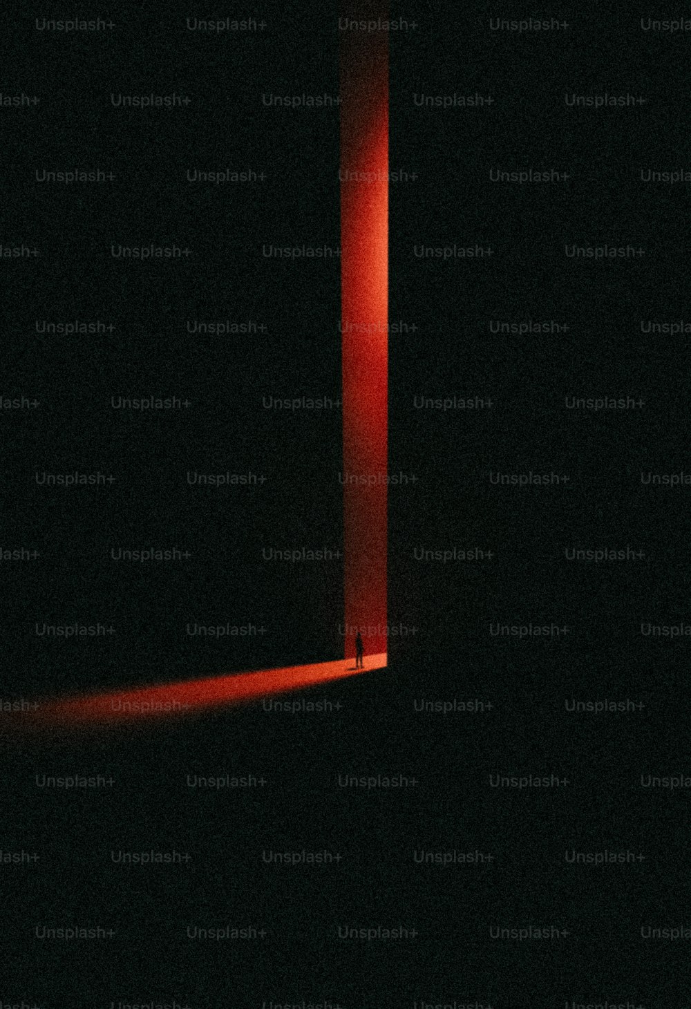 a red light shining through a dark room