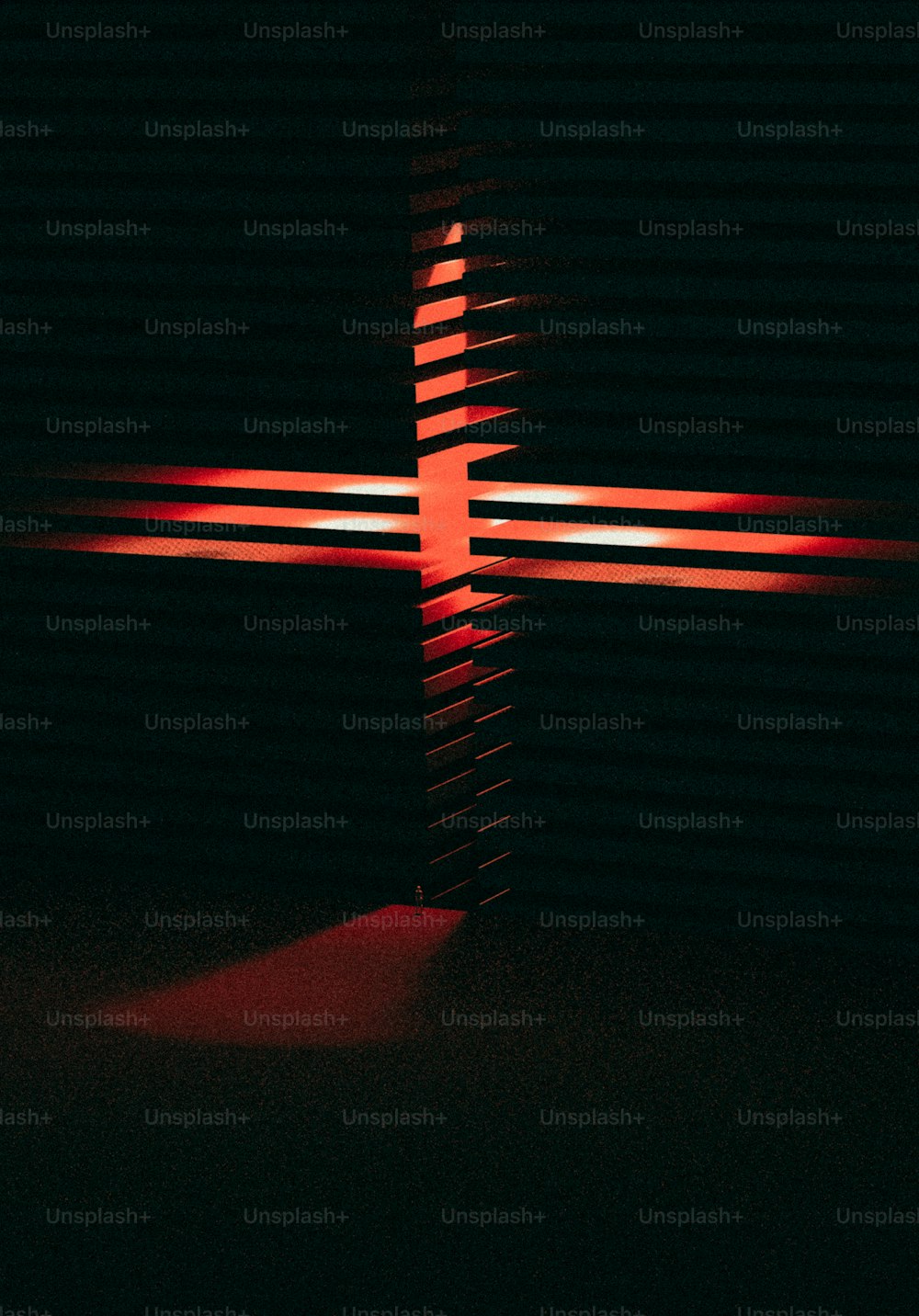 a cross is lit up in the dark