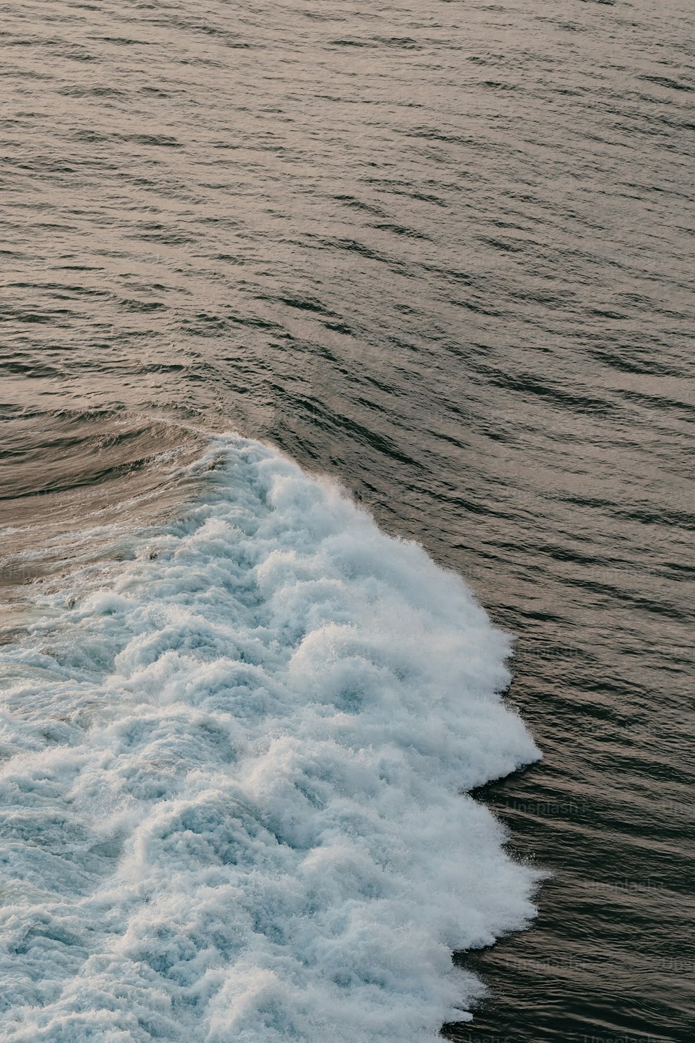 a person riding a surfboard on a wave in the ocean