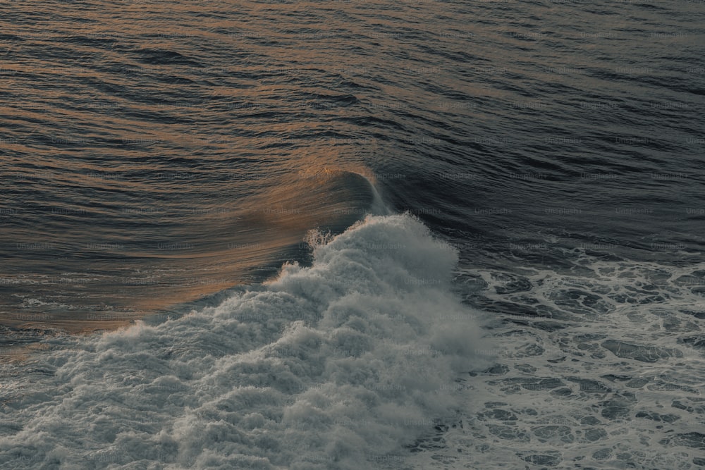 a large body of water with a wave coming in