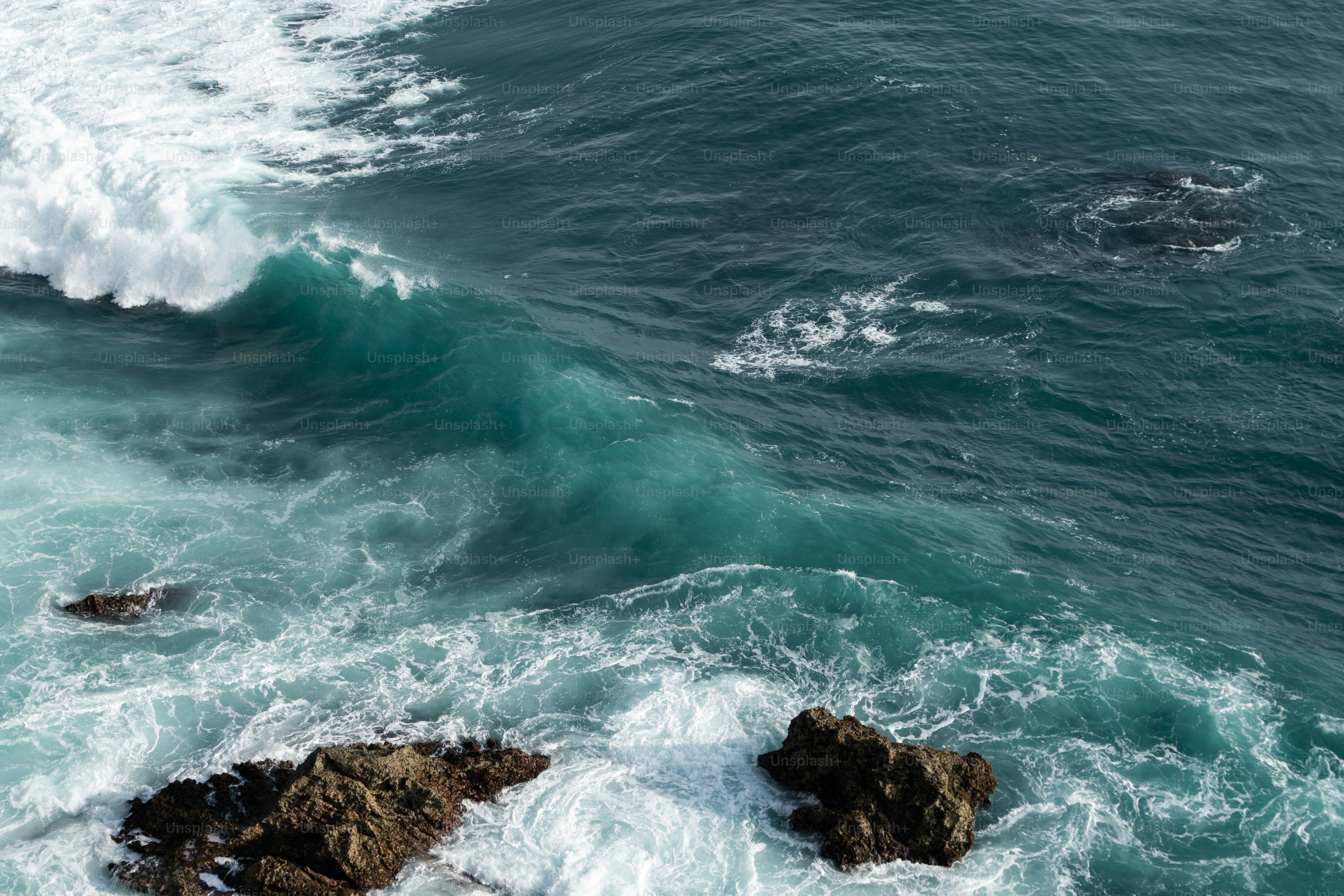 a large body of water next to a rocky shore