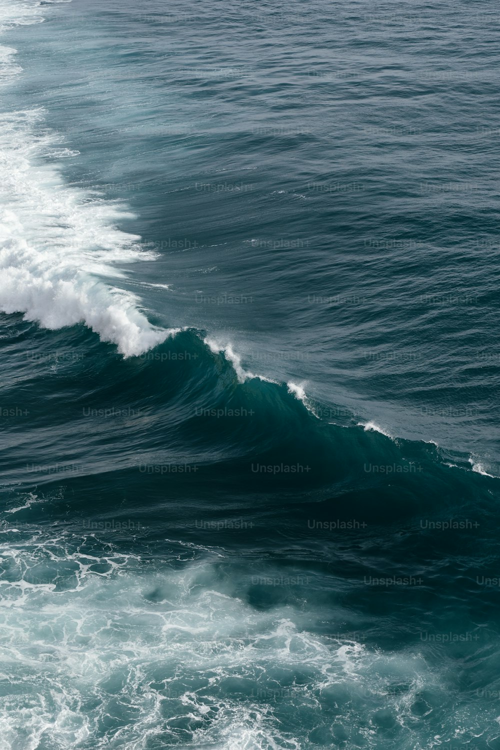 a person riding a surfboard on a wave in the ocean