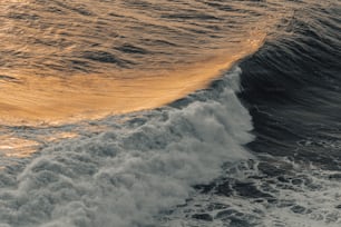 a person riding a surfboard on a wave in the ocean