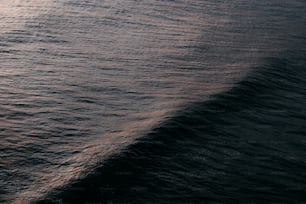 a large body of water with a boat in the distance