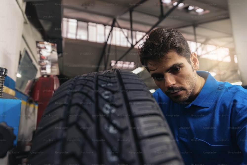 Professional Car Mechanic working in garage.