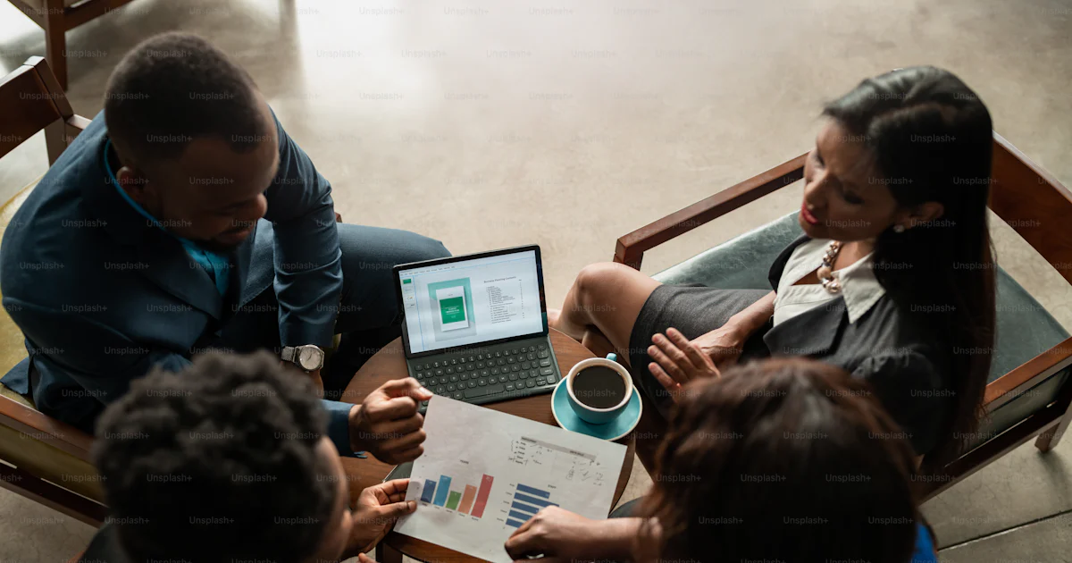 African business team reviewing charts and paperwork during a meeting
