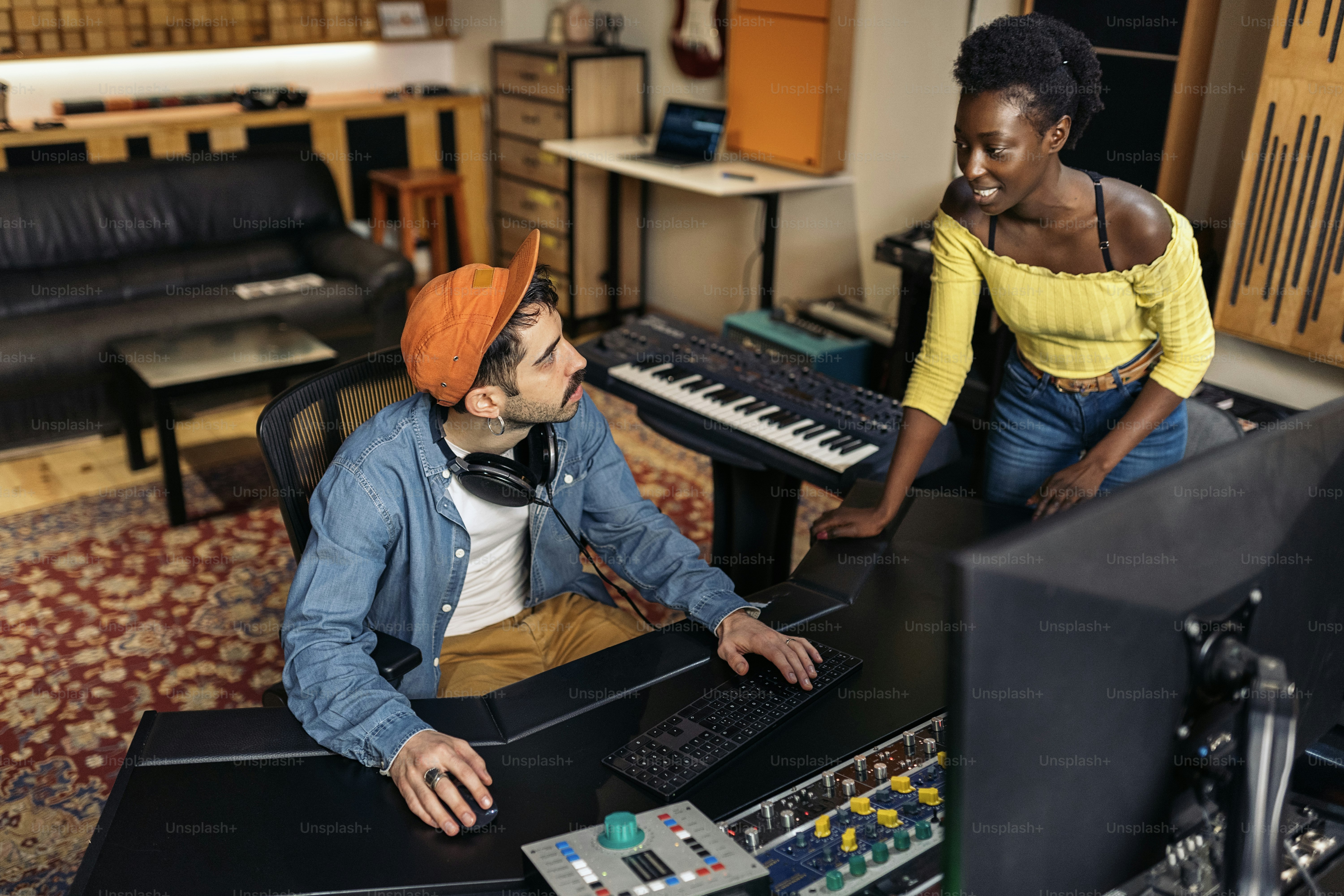Stock photo of cool artists working in professional music studio.