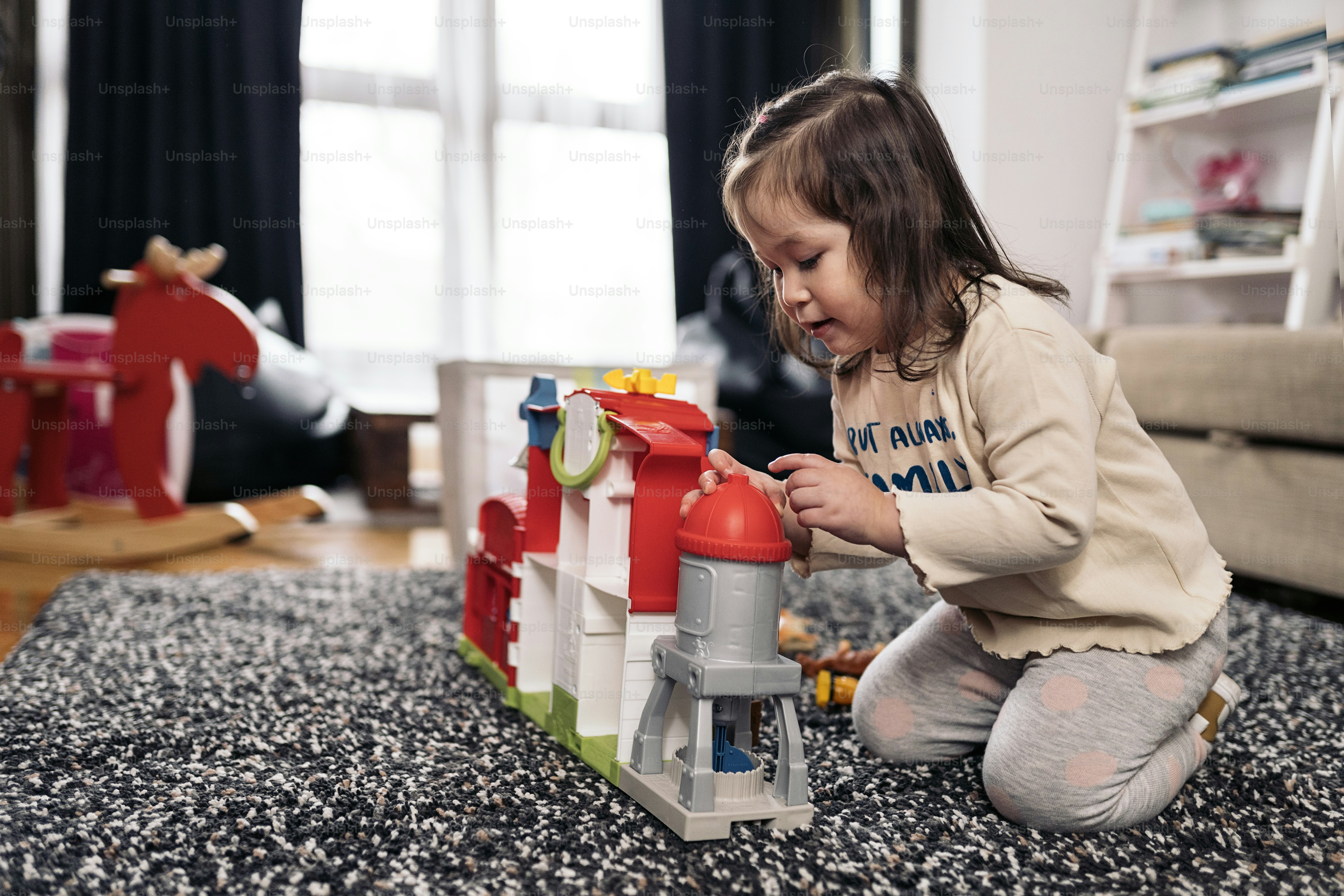Stock photo of cute little girl having fun at home playing with her ...