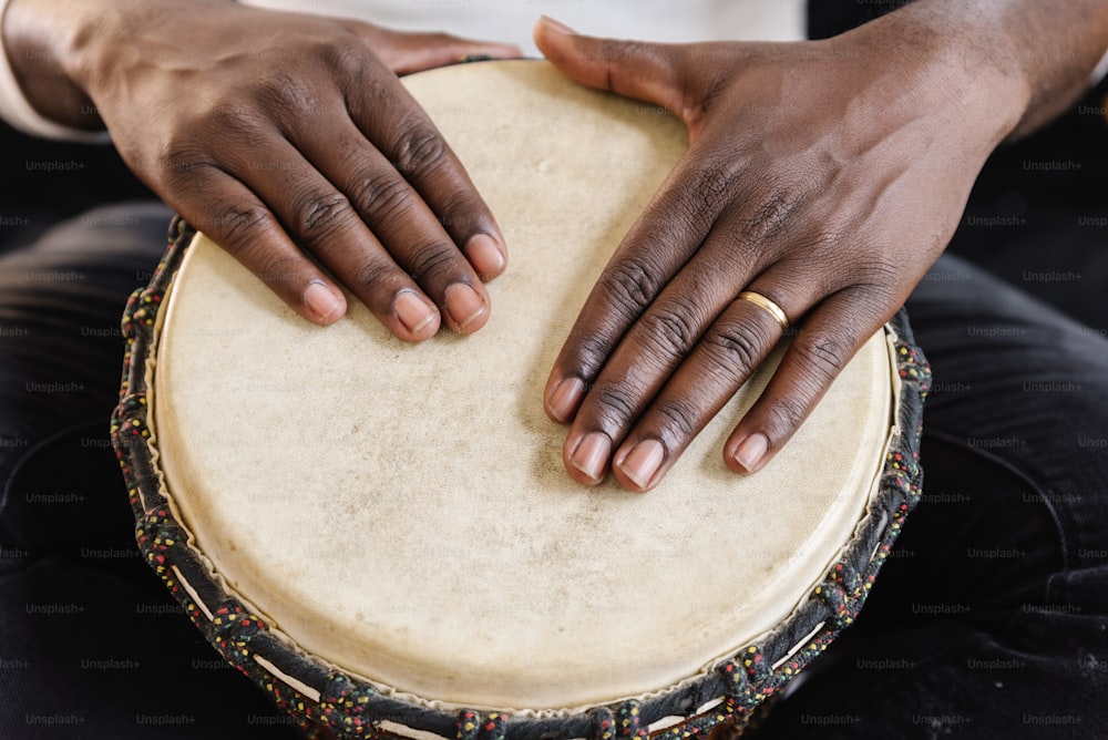 Musician Playing Drum with his hands.