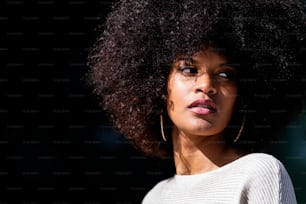 Portrait of attractive afro woman in over the wall. Hair style concept