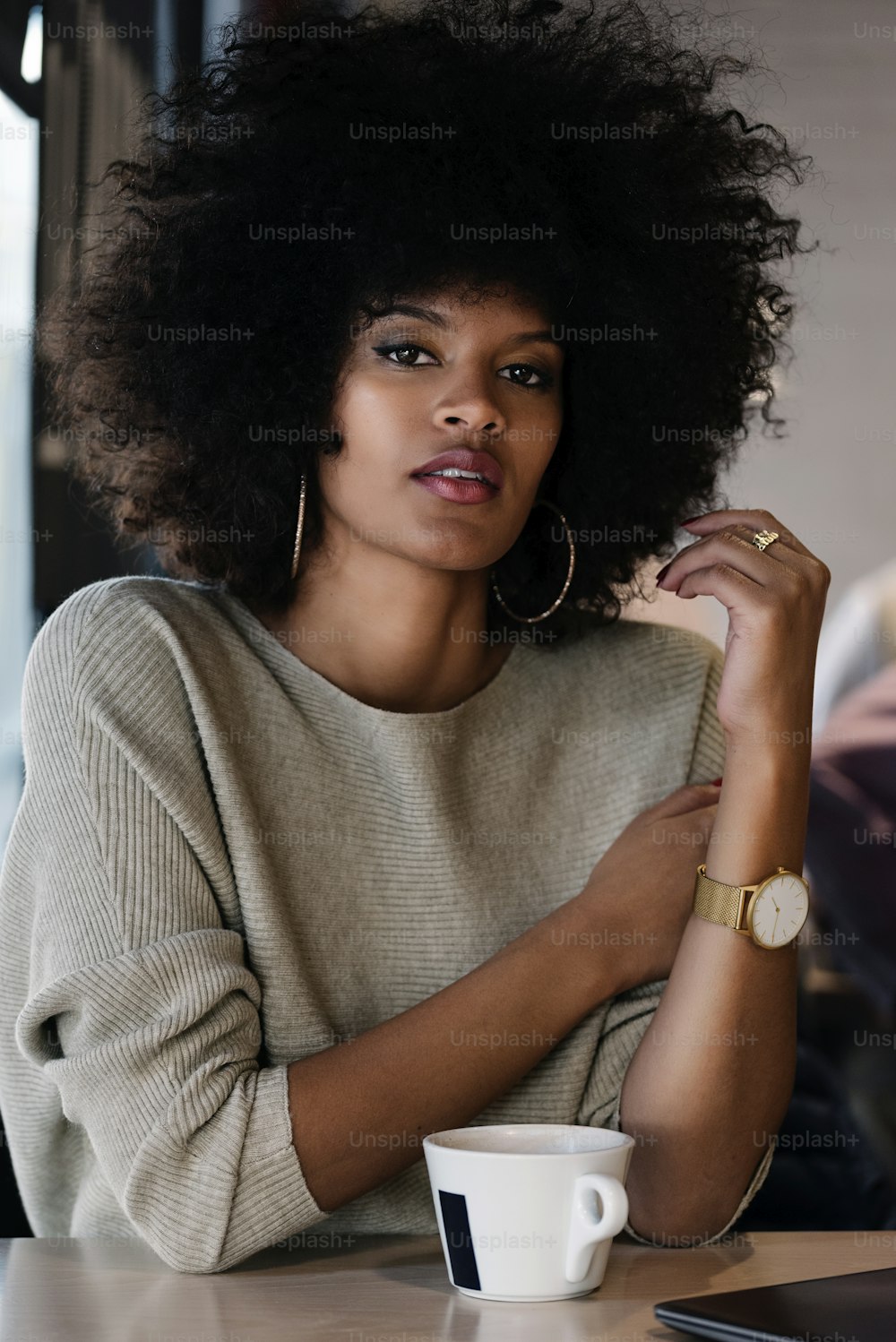 Portrait of attractive afro woman in coffee shop. Businesswoman concept