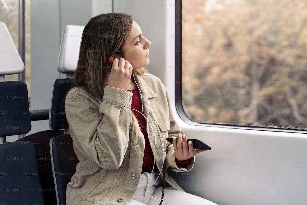 Stock photo of young attractive girl listening to music wearing headphones.