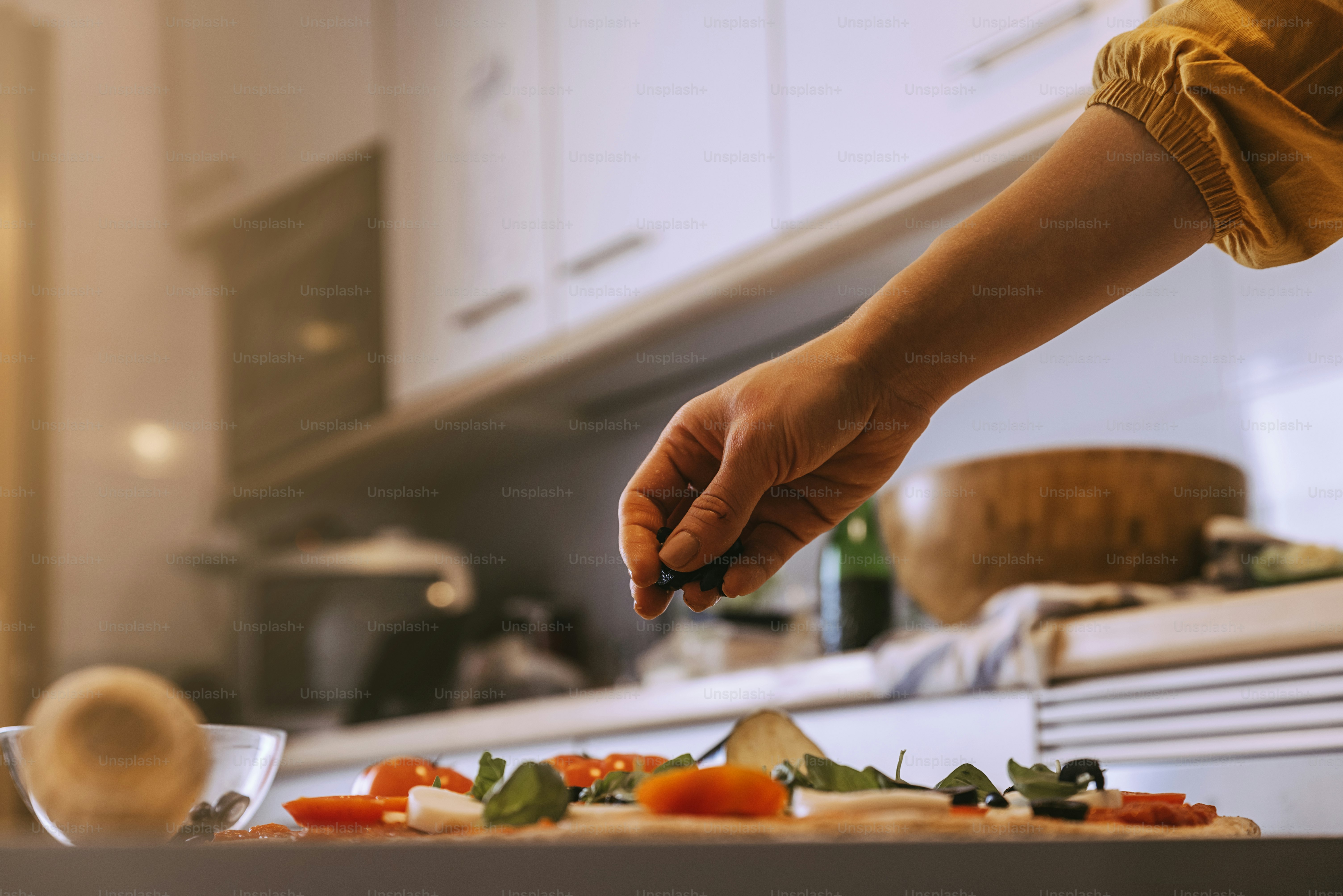 Woman adding healthy ingredients to pizza. Home made concept. photo ...