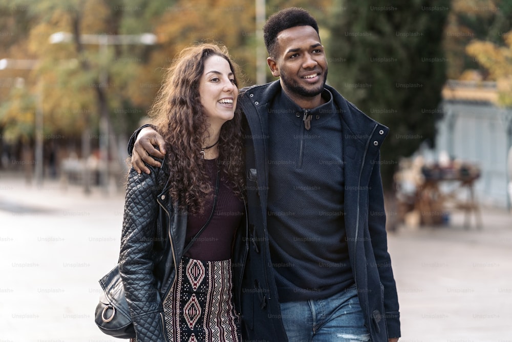 Stock photo of happy moment of interracial couple of lovers. They are in Madrid city