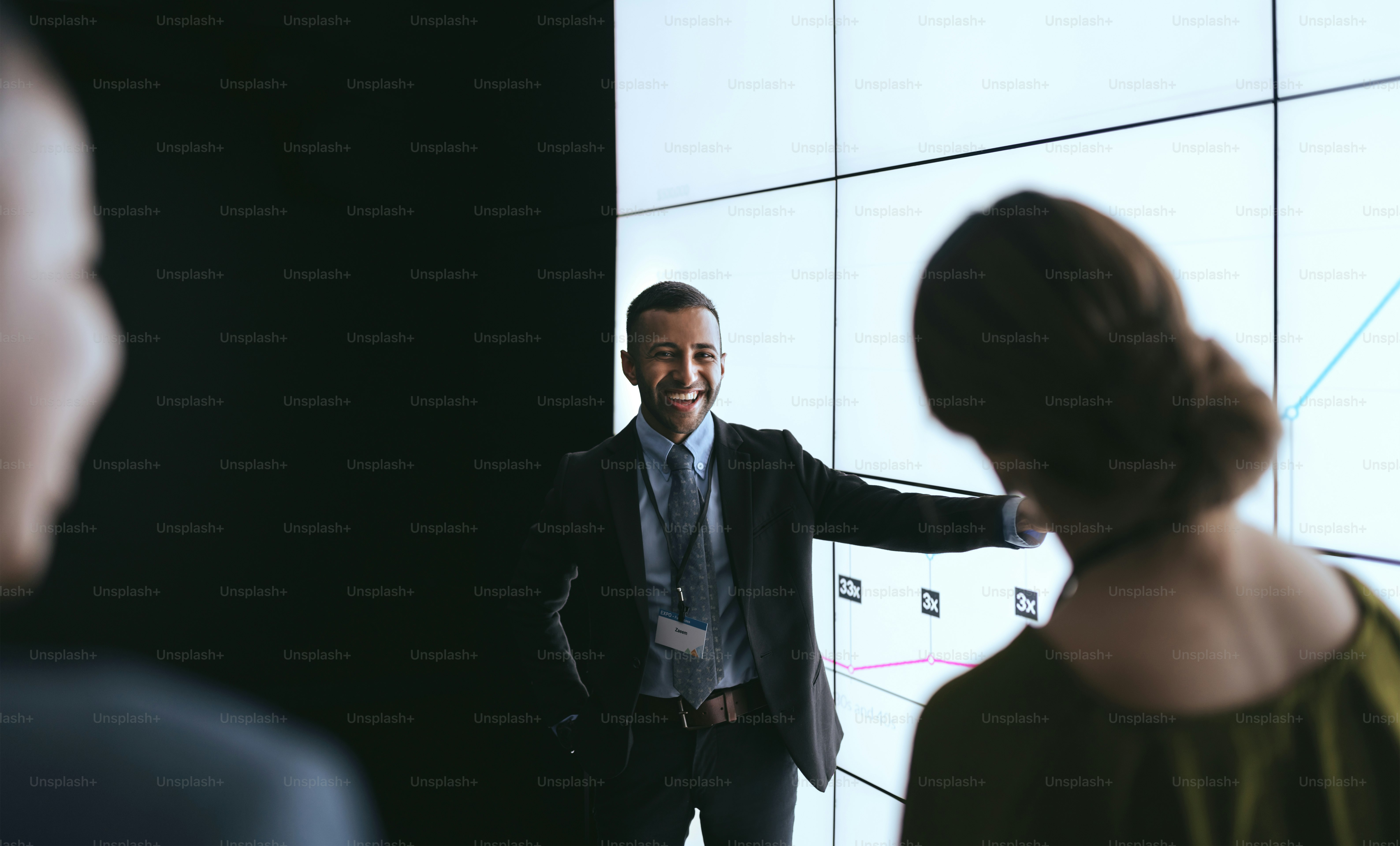 Indian businessman pointing at digital screen during a presentation