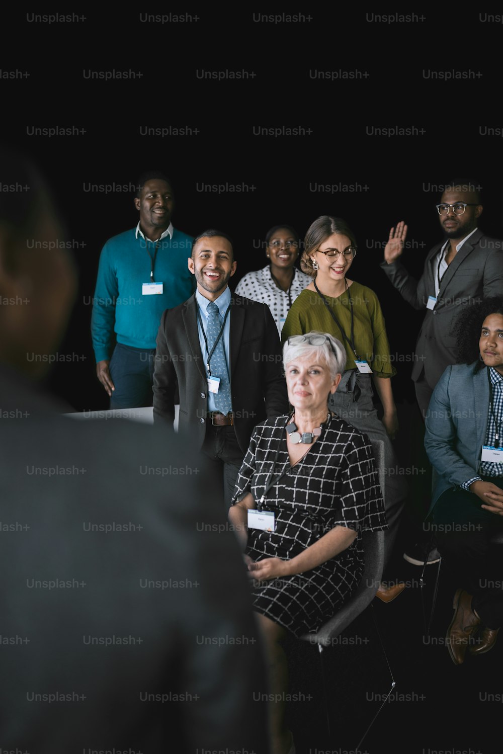 Black african businesswoman giving a presentation at a business conference. Mixed race group are interacting with her
