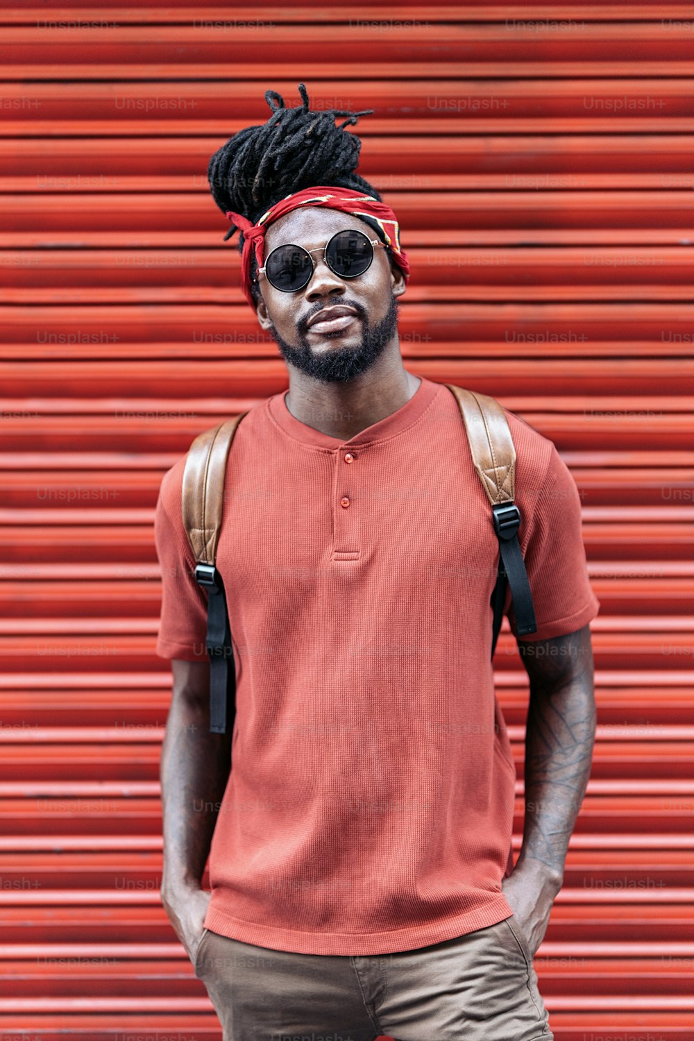 Stock photo of attractive and young african american boy wearing sunglasses. He is looking at camera.