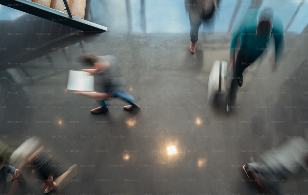 Business people walking, blurred by motion shot from a top view