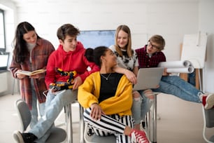 A group of students in classroom studying robotics.