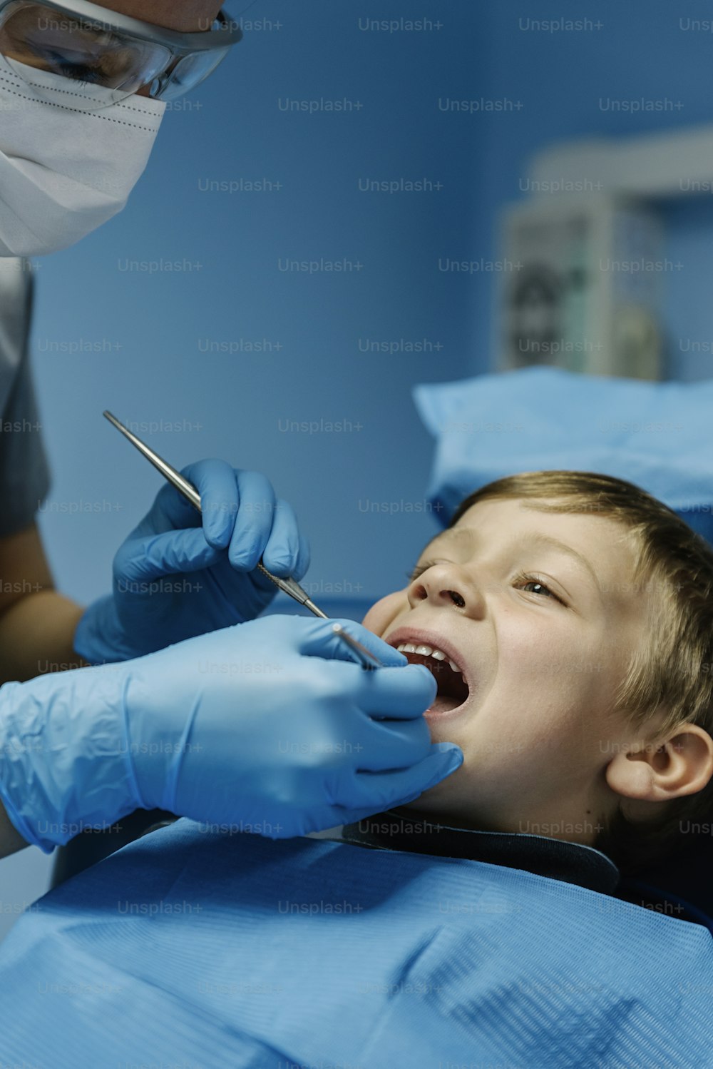 Dentists with a patient during a dental intervention to boy. Dentist Concept