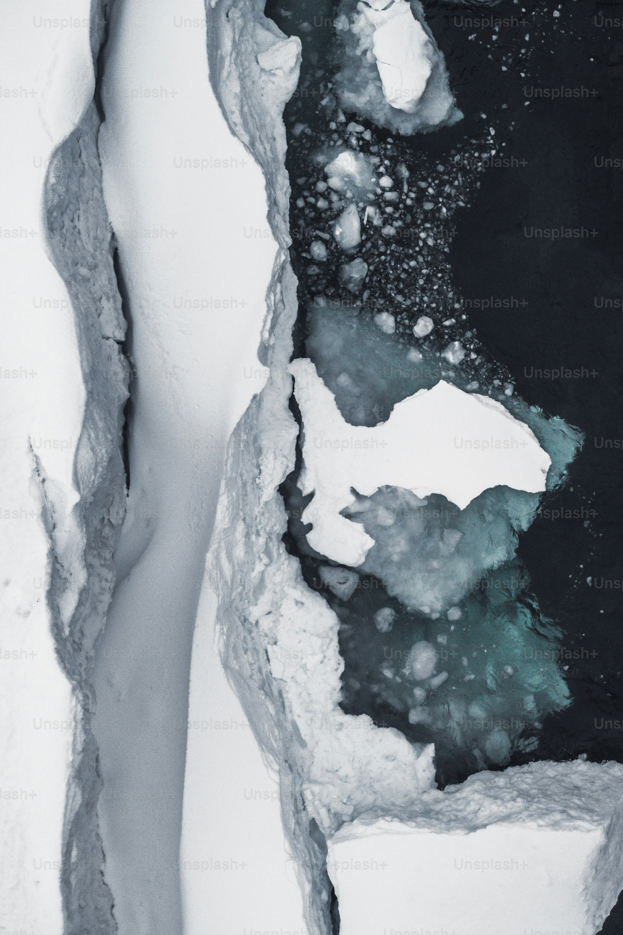 an aerial view of a snow covered river