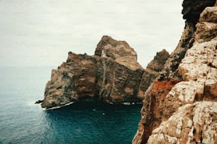 a large rock outcropping in the middle of a body of water